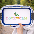 Sweatshirt with 'BOOKWORM' text and worm icon held by a person outdoors.